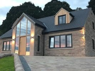 New-build house with solid oak and aluminium/oak windows and doors