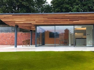 Cero slim profile sliding doors with open corner in a garden room