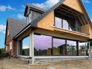Large Internorm sliding doors on a two-storey extension home with a view