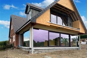 Large Internorm sliding doors on a two-storey extension home with a view