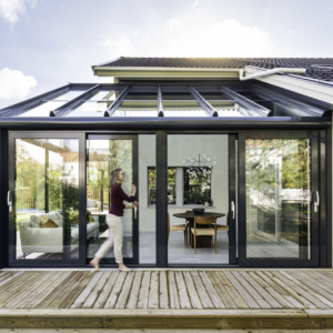 Soalrlux Wintergarden with lady opening the sliding doors