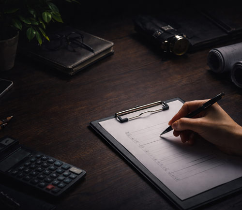 image of a hand holding a pen with an old-fashioned quote form