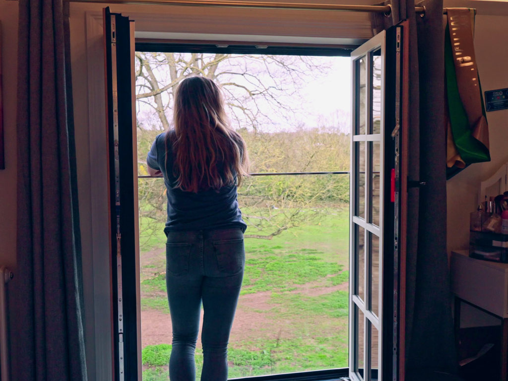 Enjoying the view from a girl's bedroom