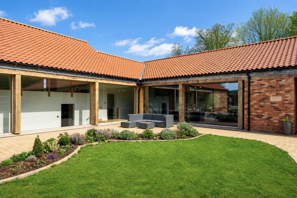 View of the courtyard with Solarlux Cero sliding doors to the right and Internorm HS330 fixed windows to the left