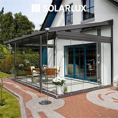 A Solarlux Glass Room covering a patio on the side of a house.jpg